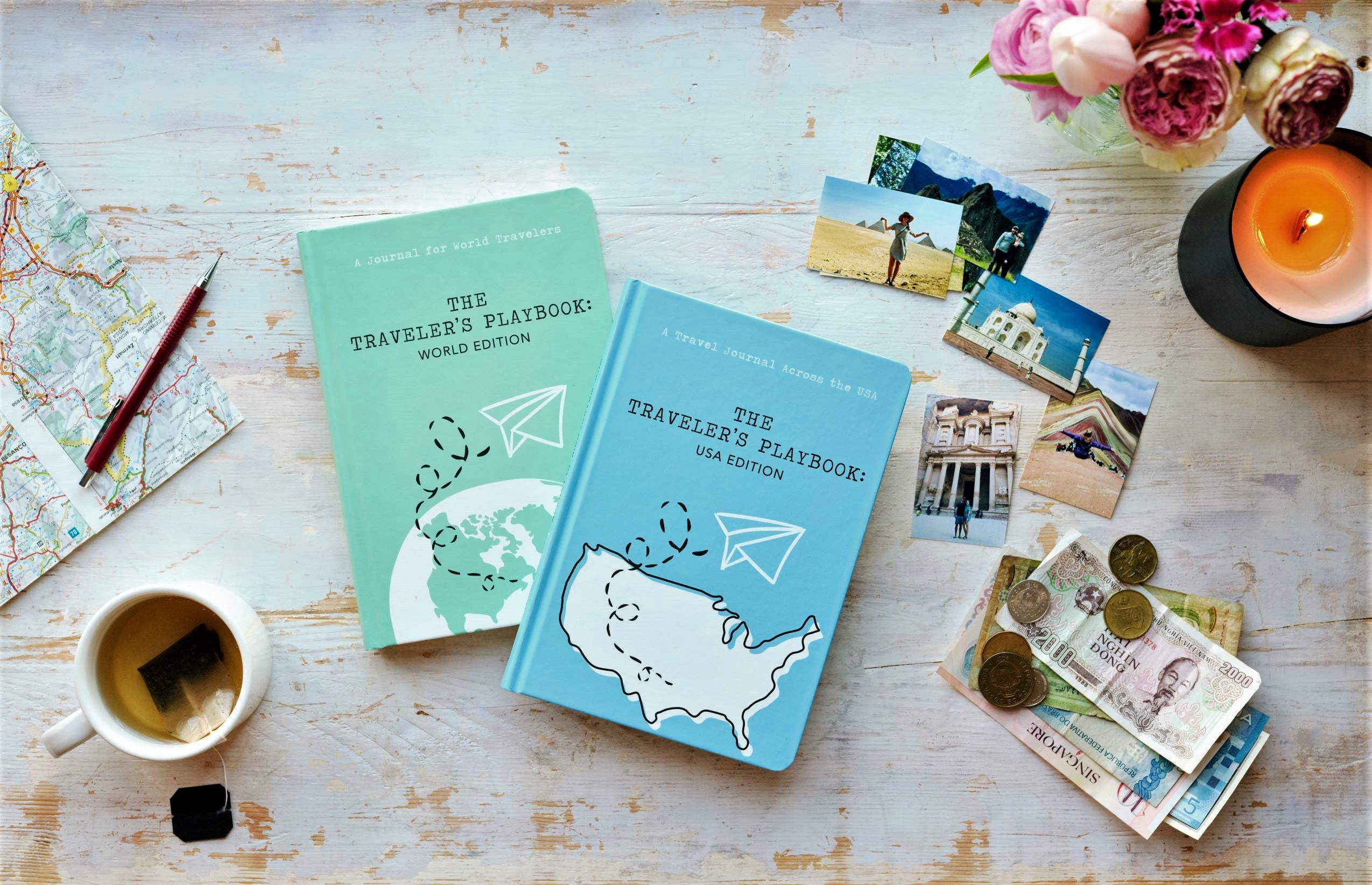 World and USA travel journals amidst a travel-themed flat lay spread